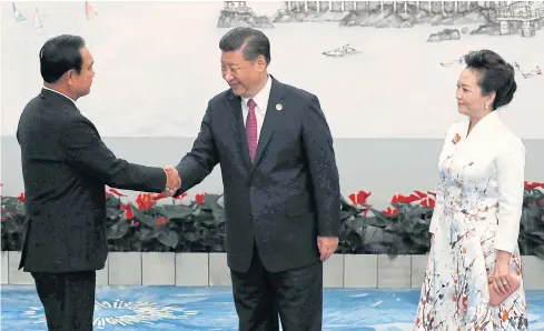  ?? REUTERS ?? Prime Minister Prayut Chan-o-cha greets Chinese President Xi Jinping and his wife Peng Liyuan at the Brics Summit in China last year.