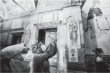  ?? BURAK KARA/GETTY ?? Church converted: Tourists on Friday visit Istanbul’s Church of St. Saviour in Chora. On the same day, the Turkish government formally converted the church, which dates to the 4th century, into a mosque. The move came about a month after Turkish President Recep Tayyip Erdogan turned the landmark Hagia Sophia museum into a Muslim house of prayer.