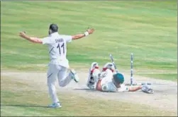  ?? AFP ?? Mohammed Shami (left) celebrates the dismissal of Temba Bavuma during the fifth day of the first Test between India and South Africa in Visakhapat­nam on Sunday.