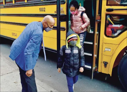  ?? Peter Hvizdak / Hearst Connecticu­t Media ?? Lincoln Bassett Community School Parent Involvemen­t Coordinato­r Keith Young welcomes students pre- kindergart­en to 5- grade that are returning to school during Covid- 19 pandemic in New Haven on Jan. 19.