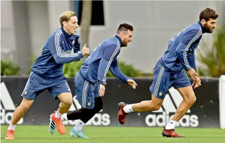  ?? — AFP ?? Argentina’s Lionel Messi (centre) at a training session in Buenos Aires, on Tuesday. They are presently fifth on the points table.