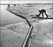  ?? Don Cormier Los Angeles Times ?? WORKERS clean up Santa Barbara’s coast after the 1969 spill that sparked the state’s aversion to drilling.
