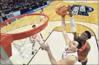  ?? Quinn Harris / Getty Images ?? Kansas’ Mitch Lightfoot shoots the ball in front of Miami’s Anthony Walker during the first half Sunday in Chicago.