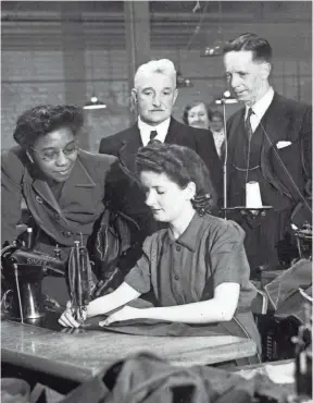  ?? KHEEL CENTER, CORNELL UNIVERSITY ?? Maida Springer-Kemp, left, of the Internatio­nal Ladies’ Garment Workers’ Union, tours a factory around 1949. She pushed for integratio­n at union events.