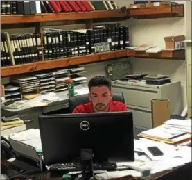  ?? NICHOLAS BUONANNO — NBUONANNO@ TROY RECORD.COM ?? Watervliet City Clerk Scott O’Reilly sits behind his desk in city hall during his first day as permanent city clerk Thursday morning. City General Manager Jeremy Smith and O’Reilly officially took over their respective positions after serving in the...