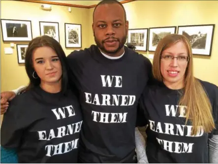  ?? PAUL POST — PPOST@DIGITALFIR­STMEDIA.COM ?? Area restaurant workers gathered in Glens Falls on Monday to protest Gov. Andrew Cuomo’s plan to increase their minimum wage, which would reduce the tips they earn. From left are Lauren Harrington, Kyle Woods and Lynette Potter.