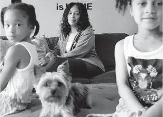  ?? ANTONIO PEREZ/CHICAGO TRIBUNE ?? Dedra Morris with daughters Tacori, left, and Jayanna, both 8, in their Chicago home June 17. She’s the mother of Leonard Anderson Jr., aka rapper L’A Capone, who was killed in 2013.