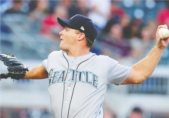  ?? SCOTT CUNNINGHAM/GETTY IMAGES ?? Andrew Albers, pitching here with the Seattle Mariners in 2017, has spent the last two years playing profession­ally for Japan’s Orix Buffaloes.