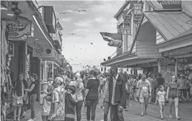  ?? STEPHEN MATHEWS PHOTO ?? The Boardwalk was full of people enjoying the sunny Saturday in Ocean City.