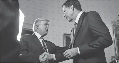  ?? ANDREW HARRER / POOL / GETTY IMAGES FILES ?? U.S. President Donald Trump shakes hands with James Comey, then director of the FBI, at the White House in January 2017. Trump unleashed a volley of tweets criticizin­g Comey as details of his tell-all book come to light.