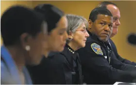  ?? Paul Chinn / The Chronicle ?? Oakland Police Chief Anne Kirkpatric­k (center) and San Francisco Police Chief Bill Scott appear at an Oakland panel discussion on a current hot-button topic in community policing: officer-involved shootings.