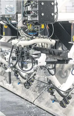  ?? BLOOMBERG ?? Non-destructiv­e inspection robots inspect wing spars on Boeing’s 777X aeroplane operate on the assembly floor of its facility in Everett, Washington, on March 6, 2019.