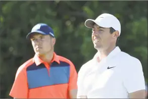  ?? Rob Carr / Getty Images ?? Jordan Spieth, left, and Rory McIlroy wait on the 11th tee during the first round of the U.S. Open at Shinnecock Hills Golf Club on Thursday in Southampto­n, N.Y.