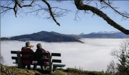  ?? — AFP file photo ?? An elderly couple sits on a bench above fog hanging in the valley of Hochwacht mountain above Zug, central Switzerlan­d. Researcher­s in Denmark are developing an algorithm to help predict the stages of life all the way to the end, dubbed a “death calculator”, it also highlights the dangers of misusing data.