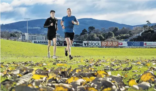  ?? PHOTO: GERARD O’BRIEN ?? Ready to run . . . Oli Chignell (left) and Richard Fogerty check out the conditions yesterday before the Lovelock relays at the University of Otago Oval today.
