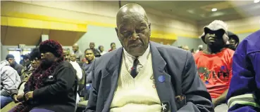  ?? Picture: Masi Losi ?? Galatlhwe Isaac Mogale of the Ramalebye Moeletsi Community Property Associatio­n closes his eyes for a moment as he prepares his papers during the public hearing on land rights at the Rustenburg civic centre in North West this week.