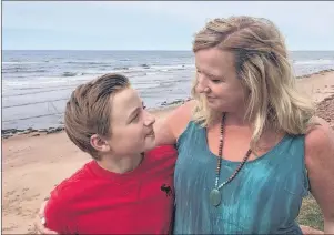  ?? 46#.*55&% 1)050 ?? Beth Johnston and her son, Charlie Ross, are shown on the beach in Savage Harbour Monday where they had the fright of their lives Saturday evening after getting caught in a rip current.