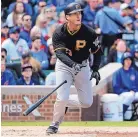  ?? JEFF HAYNES/ASSOCIATED PRESS ?? Pittsburgh third baseman David Freese watches his RBI double in the second inning during the Pirates’ win over the Cubs in Wrigley Field.