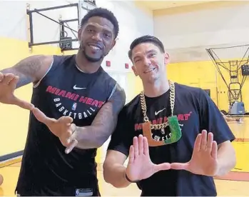  ?? MIAMI HEAT/COURTESY ?? Heat forward and co-captain Udonis Haslem, left, shows his support for the Miami Hurricanes football team next to Heat assistant coach, and former Irish player, Chris Quinn. The two had a bet on Saturday’s game between UM and Notre Dame.