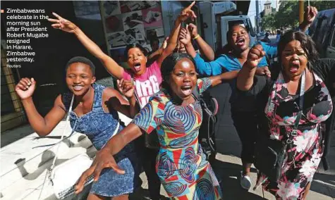  ?? Reuters ?? Zimbabwean­s celebrate in the morning sun after President Robert Mugabe resigned in Harare, Zimbabwe yesterday.