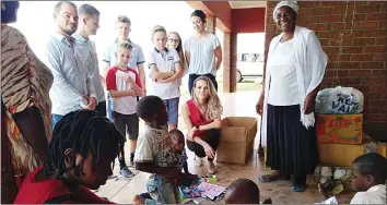  ??  ?? House of Assembly member Vangelis Haritatos and his family donate foodstuffs and toys at a children’s home in Kadoma on Christmas Day