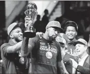  ?? / AP - Tony Dejak ?? Kevin Durant lifts the NBA Finals MVP trophy for the second time in as many years with the Warriors.