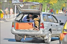  ??  ?? People take the coffin of a terror attack victim in a car in Kabul on Friday.