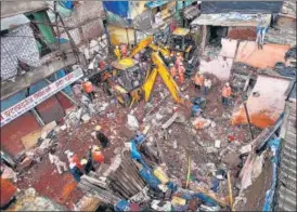  ?? AP ?? Rescuers clear the debris to find any residents possibly still trapped after a three-storey dilapidate­d building collapsed in Mumbai on Thursday.