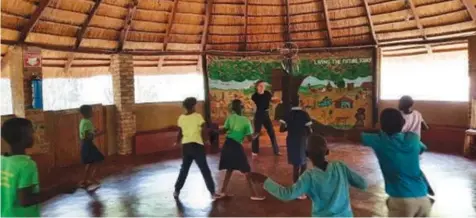  ?? ?? Yarrow Hogan during a movement class in a Kufunda village gazebo outside Harare, Zimbabwe.