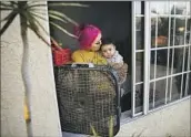  ?? JASON ARMOND LOS ANGELES TIMES ?? KAREN Tapia and daughter Jessalyn cool off with a window fan. Their L.A. home has no air conditioni­ng.