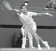  ?? AP/NIC BOTHMA ?? Novak Djokovic returns a ball to Rafael Nadal during Saturday’s Wimbledon men’s singles semifinal match in London. Djokovic won 6-4, 3-6, 7-6 (9), 3-6, 10-8 to advance to today’s final against Kevin Anderson.