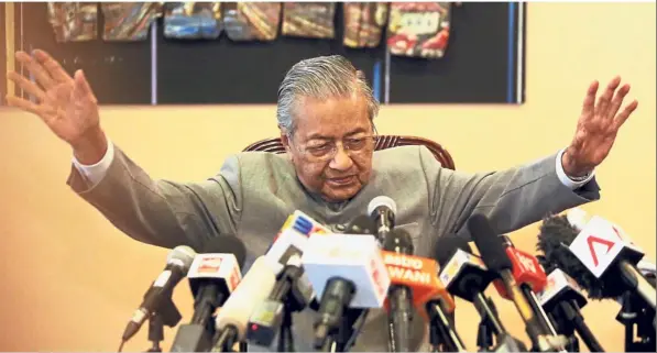  ??  ?? Man of the hour: Tun Dr Mahathir reacting to questions during a press conference at the Perdana Leadership Foundation in Putrajaya. — AZHAR MAHFOF / The Star