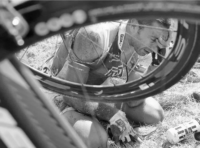  ?? Christophe­Ena /theasociat edpress ?? France’s William Bonnet holds his head in pain after crashing with several other riders during the third stage of the Tour de Franceon Monday in Belgium. Bonnet was taken off on a stretcher with a brace around his neck following the crash.