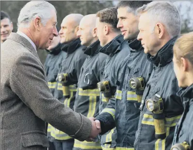  ?? PICTURES: CHRIS ETCHELLS ?? VISIT:
The Prince of Wales meets emergency services workers before touring the village of Fishlake.
