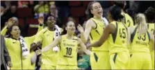  ?? ELAINE THOMPSON — THE ASSOCIATED PRESS FILE ?? From left, the Seattle Storm’s Alysha Clark, Natasha Howard, Sue Bird and Breanna Stewart come off the bench to greet teammates during a timeout in a June game in Seattle. combined to set rookie record for 3-pointers made in a season with 127 so far.Elena Delle Donne averaged 27.7 points, 5.7 rebounds, 2.3 assists to help Washington go 3-0 this week. Candace Parker of Los Angeles also received votes.