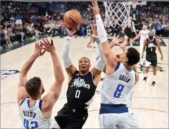  ?? Los Angeles Clippers guard Russell Westbrook, center, shoots as Dallas Mavericks forward Maxi Kleber, left, and guard Josh Green defend during Game 2 Tuesday, in Los Angeles. ?? THE ASSOCIATED PRESS