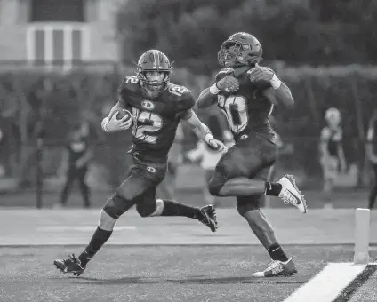  ?? Leslie Plaza Johnson / Contributo­r ?? Dickinson quarterbac­k Luke Martin (12) scores a touchdown in the first quarter during Friday’s game against the Dobie Longhorns at Vitanza Stadium in Dickinson.