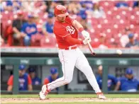  ?? AP Photo/Aaron Doster ?? ■ Cincinnati Reds’ Kyle Farmer hits a two-run single Thursday during the sixth inning of a baseball game against the Chicago Cubs in Cincinnati.