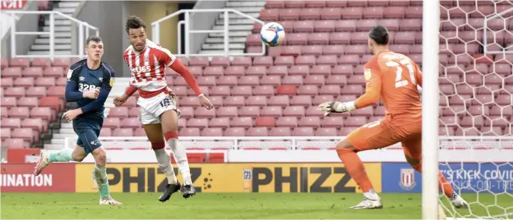  ??  ?? HEAD BOY: Stoke’s Jacob Brown heads past Kelle Roos to score the only goal of the game against Derby.