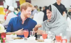  ??  ?? Harry speaks to Nazhath Faheema, a Muslim Youth Ambassador of Peace, as they eat an evening meal to break fast, or the iftar, for Ramadan, during a visit to a children's home in Singapore. — Reuters photo