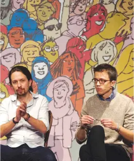  ??  ?? MADRID: This file photo shows leader of left wing party Podemos Pablo Iglesias (L) and Podemos member Inigo Errejon applauding during The Congress on your Square meeting held at El Pozo cultural center in Vallecas, a neighborho­od of Madrid.