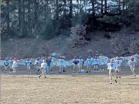  ?? NICK MALLARD / SENTINEL & ENTERPRISE ?? St. Bernard’s players run through a drill during Friday afternoon’s football practice.