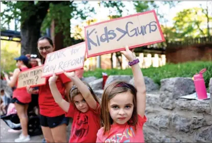  ?? JASON KEMPIN / GETTY IMAGES ?? Children participat­e in a demonstrat­ion in support of gun control laws sponsored by Voices for a Safer Tennessee, near Vanderbilt University in Nashville, Tennessee, on April 18. The event was in response to the mass shooting on March 27 at The Covenant School in Nashville, where three 9-year-old students and three adults were killed by a 28-year-old former student.