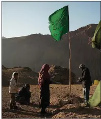  ?? The New York Times/KIANA HAYERI ?? Mohammad Bakhsh and his family visit his sons’ graves near Dahana-e-Ahangaran, Afghanista­n, in late October, something they do every week. Explosives left over from decades of war remain a constant danger in the country.