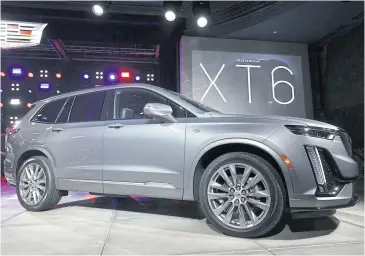  ?? GETTY IMAGES/AFP ?? ABOVE The Cadillac XT6 three-row crossover SUV is revealed at the Garden Theater in Detroit on Sunday.