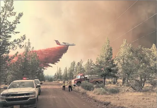  ?? COURTESY OF OREGON DEPARTMENT OF FORESTRY VIA AP ?? A firefighti­ng tanker makes a retardant drop over the Grandview Fire near Sisters, Ore., on Sunday. Jet fuel shortages could hamper firefighti­ng during a busy wildfire season in the Western United States.