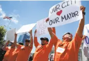  ?? Paul Chinn / The Chronicle ?? Paolo Martinez (right) and other union members rally in July to oppose recalling Mayor Ed Lee.