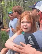  ?? CLAY CARSON VIA AP ?? Rescuers carry 4-year-old Vadie Sides out of the woods in Lee County, Ala., Friday. Lee County Sheriff Jay Jones said the girl was found with a dog at her side after two days in the woods. Authoritie­s said the girl wandered away from a sitter while in a backyard.