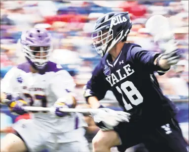  ?? Maddie Meyer / Getty Images ?? Yale’s Jack Tigh (18) is defended by albany’s Anthony Altimiri on Saturday.