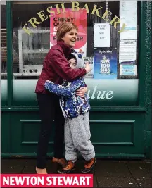  ??  ?? Hug: Finton Kane welcomes Nicola Sturgeon to town